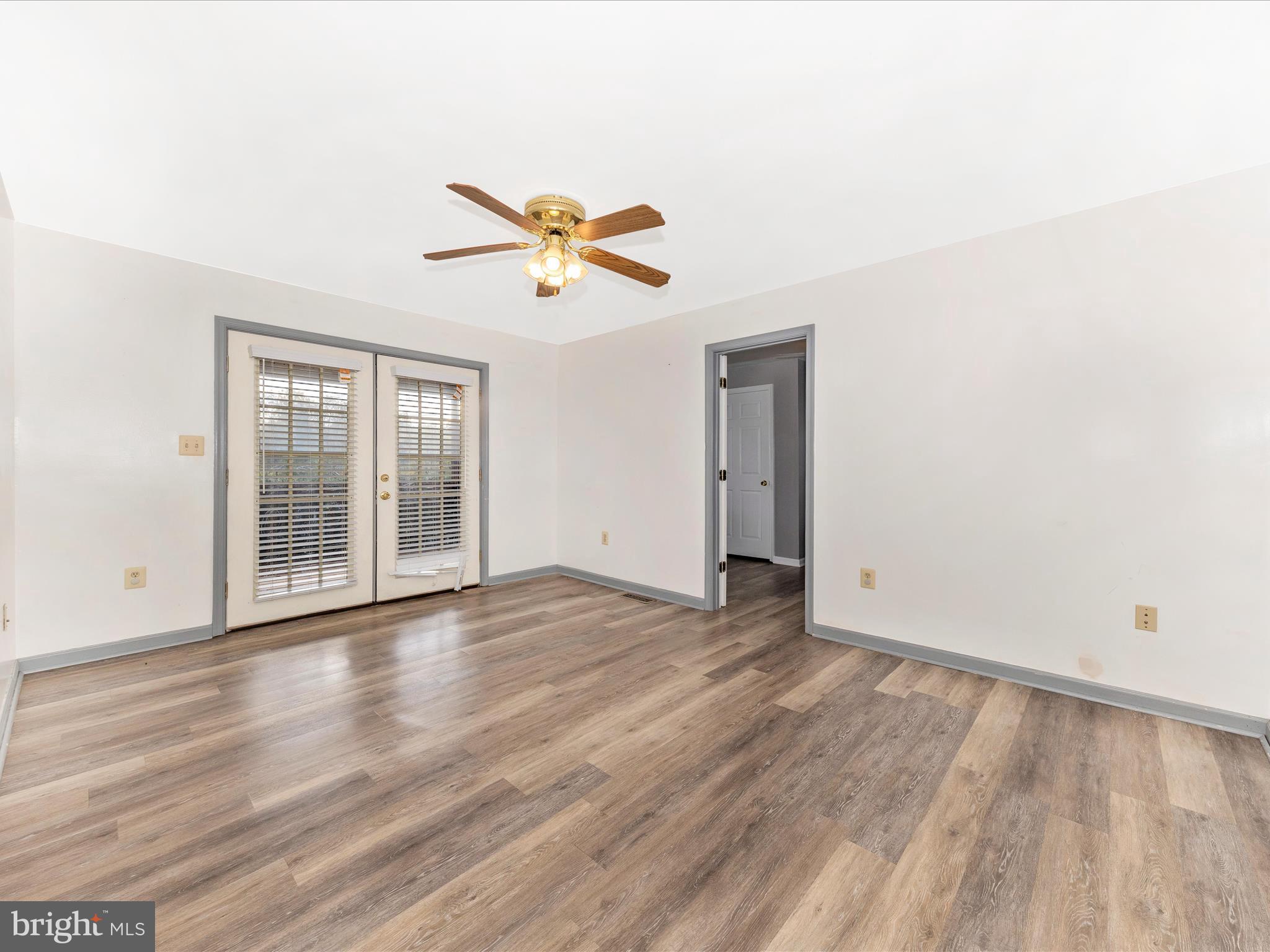 9320 Rocky Ridge Road Rocky Ridge, MD 21778 - Photo 8 of 54 an empty room with wooden floor and windows