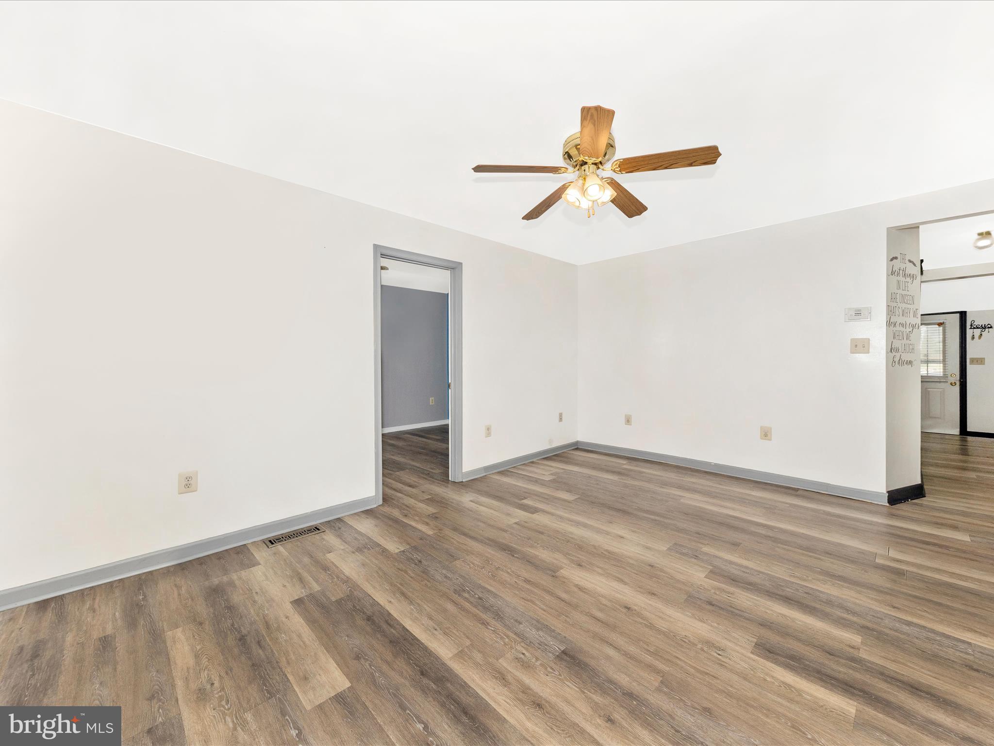 9320 Rocky Ridge Road Rocky Ridge, MD 21778 - Photo 10 of 54 a view of a room with wooden floor and ceiling fan