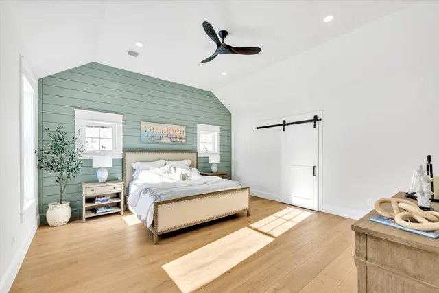 a bedroom with a large bed and a chandelier