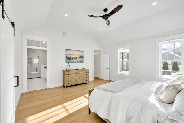 a large bathroom with a double vanity sink a mirror and a bathtub