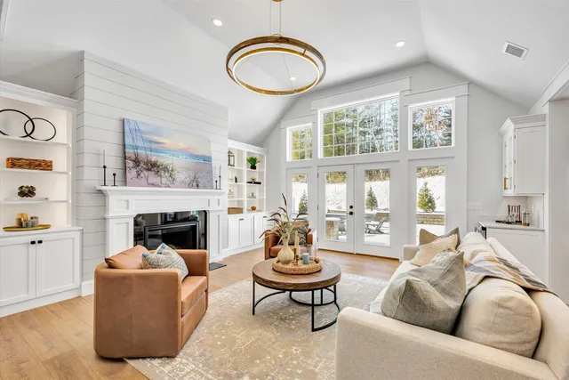 a living room with furniture a fireplace and window