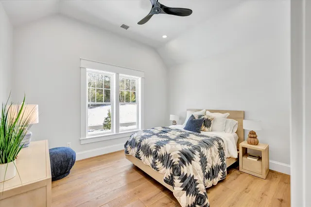 a kitchen with a sink and wooden floor