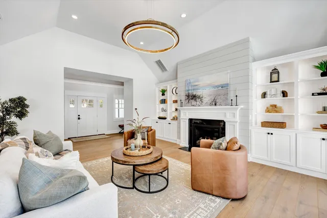 a living room with furniture and a fireplace