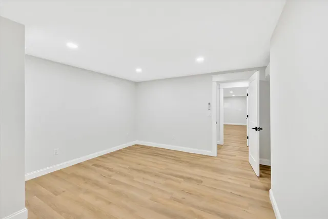 a view of swimming pool with seating space and trees in the background