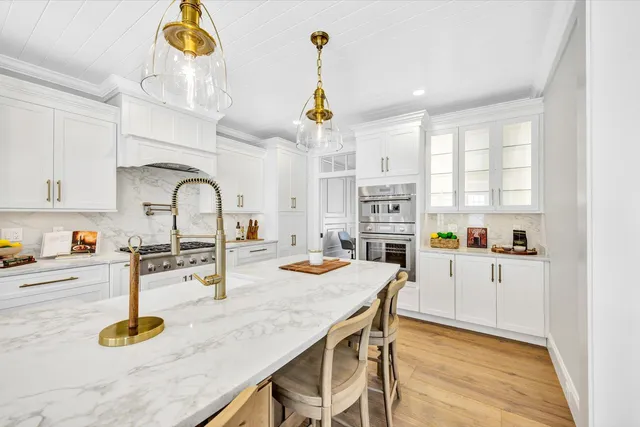 a kitchen with sink refrigerator and stove