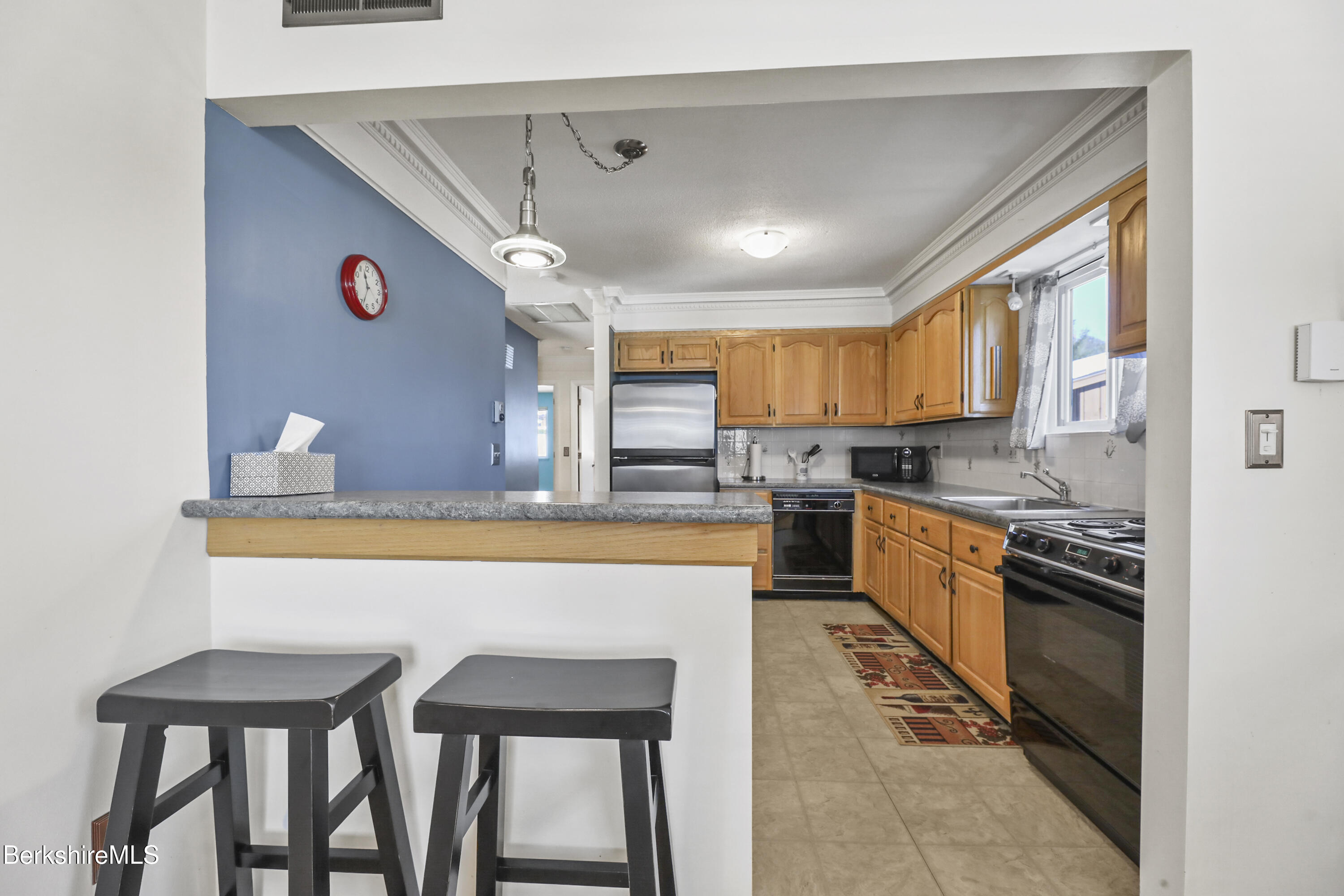 44 Churchill Crest, Unit 44 Pittsfield, MA 01201 - Photo 11 of 25 a kitchen with granite countertop a sink stainless steel appliances and cabinets