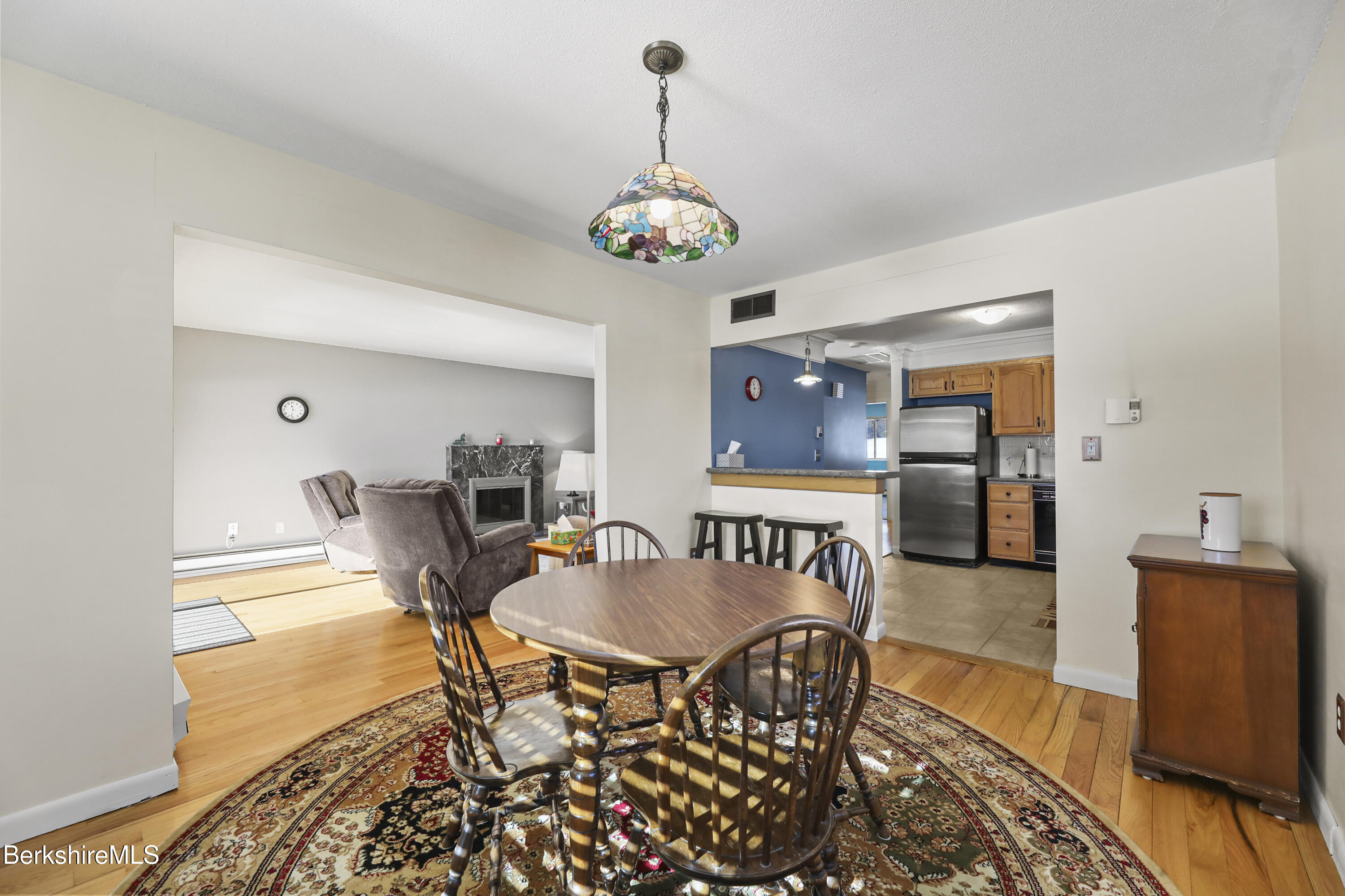 44 Churchill Crest, Unit 44 Pittsfield, MA 01201 - Photo 10 of 25 a view of a dining room with furniture wooden floor and a chandelier