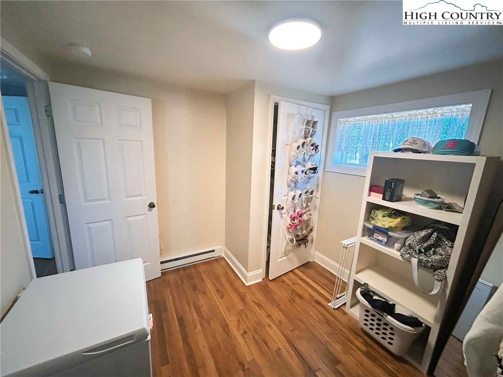 1145 Lazy Branch Road Ennice, NC 28623 - Photo 12 of 13 a view of a hallway with workspace and wooden floor