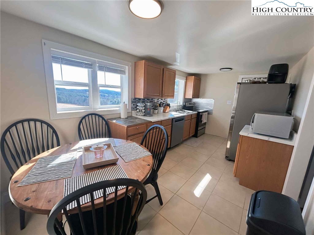 1145 Lazy Branch Road Ennice, NC 28623 - Photo 6 of 13 a view of a dining room with furniture window and outside view