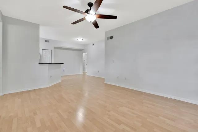 an empty room with a ceiling fan and a ceiling fan