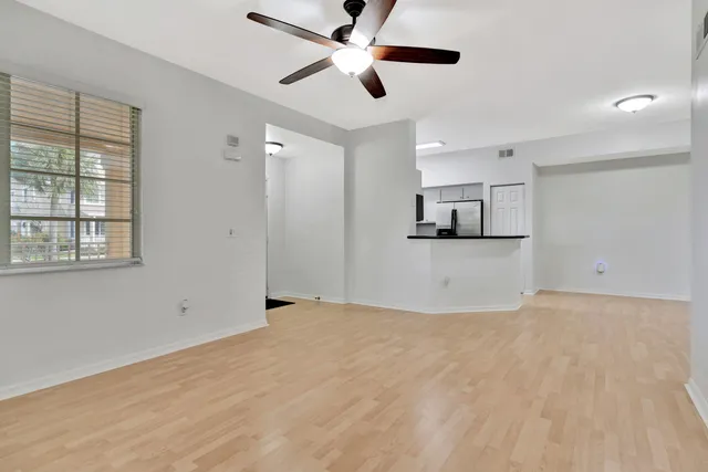 a view of a room with window and ceiling fan