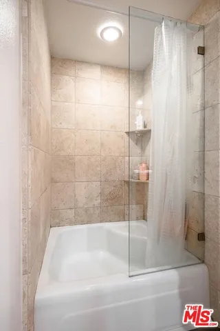 a bathroom with a bathtub and a shower