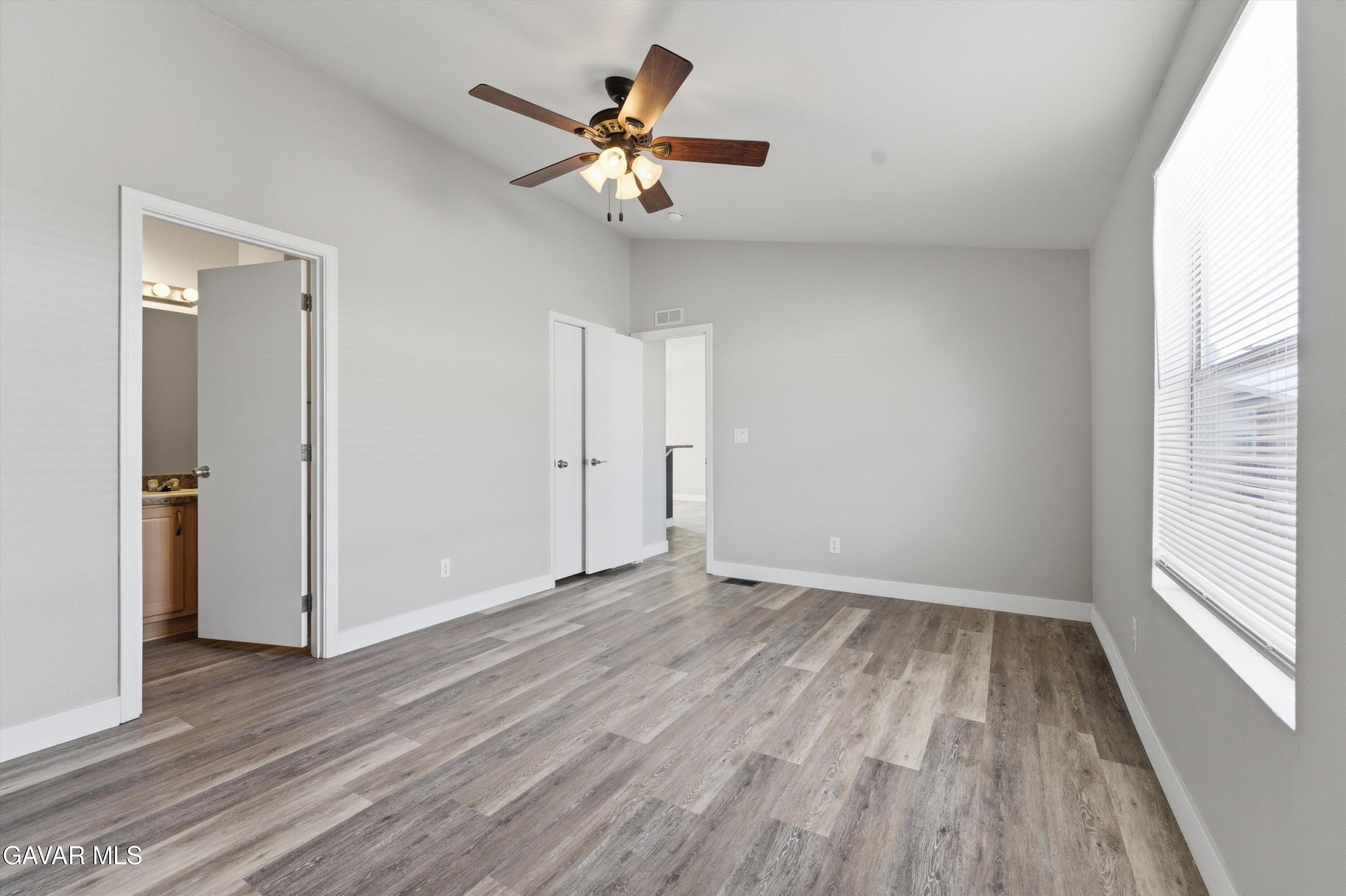 20843 Waalew Road Apple Valley, CA 92307 - Photo 14 of 40 a view of a room with wooden floor and a ceiling fan