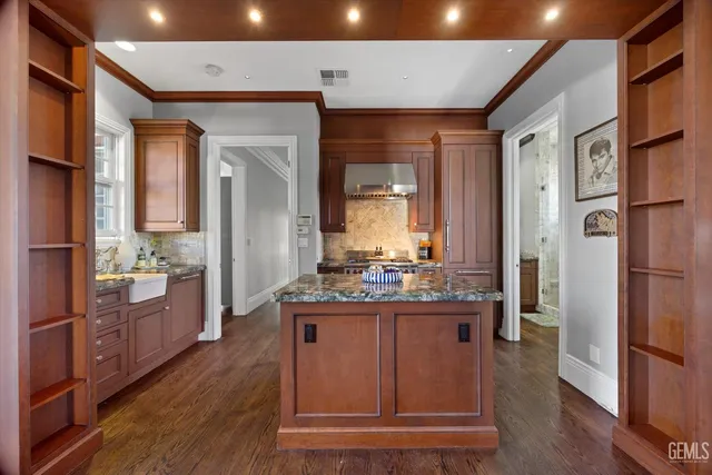 a spacious bedroom with a bed and a flat screen tv