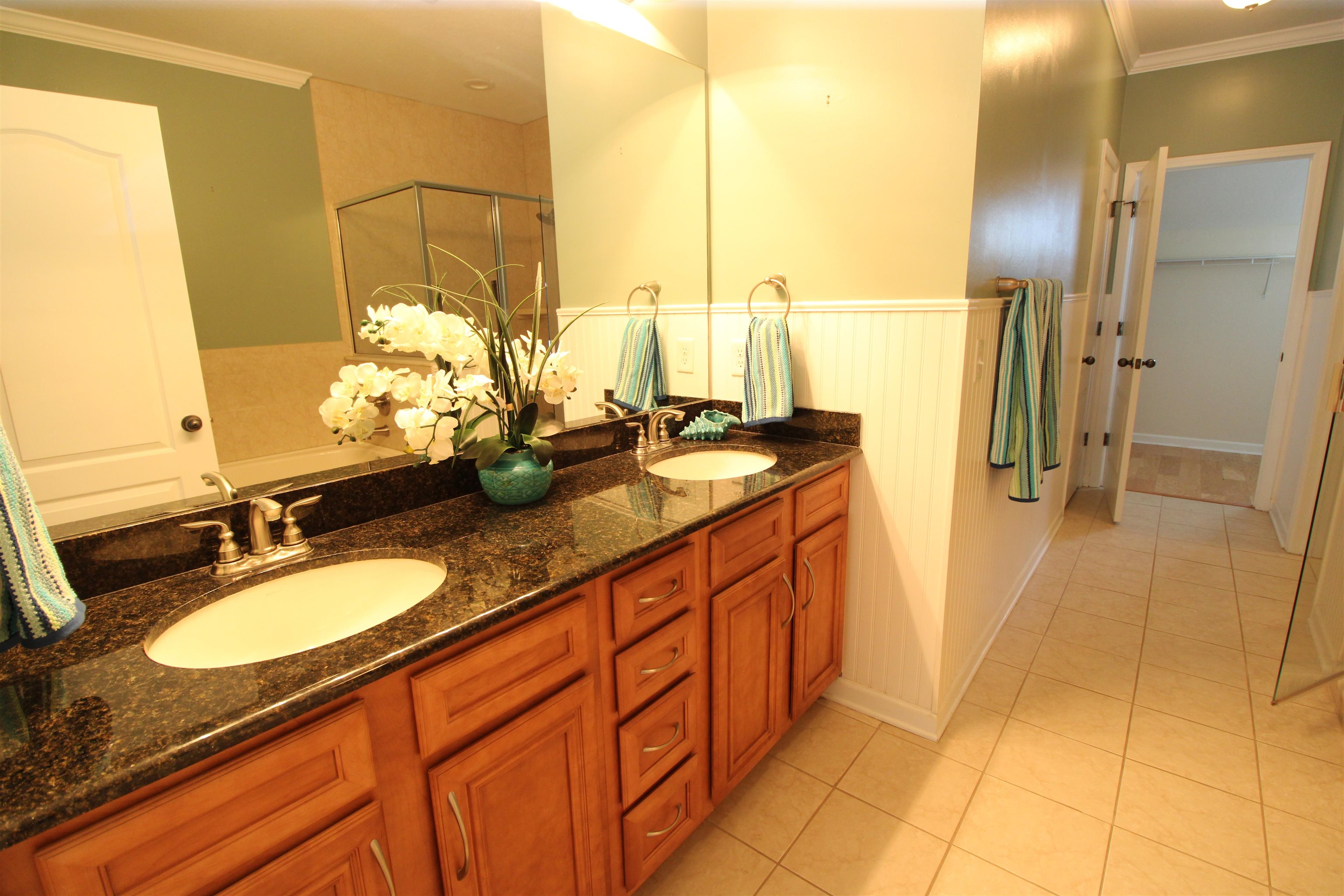 110 Magnolia Crossing Point, Unit 1905 St. Augustine, FL 32086 - Photo 20 of 42 a bathroom with a granite countertop sink and a mirror