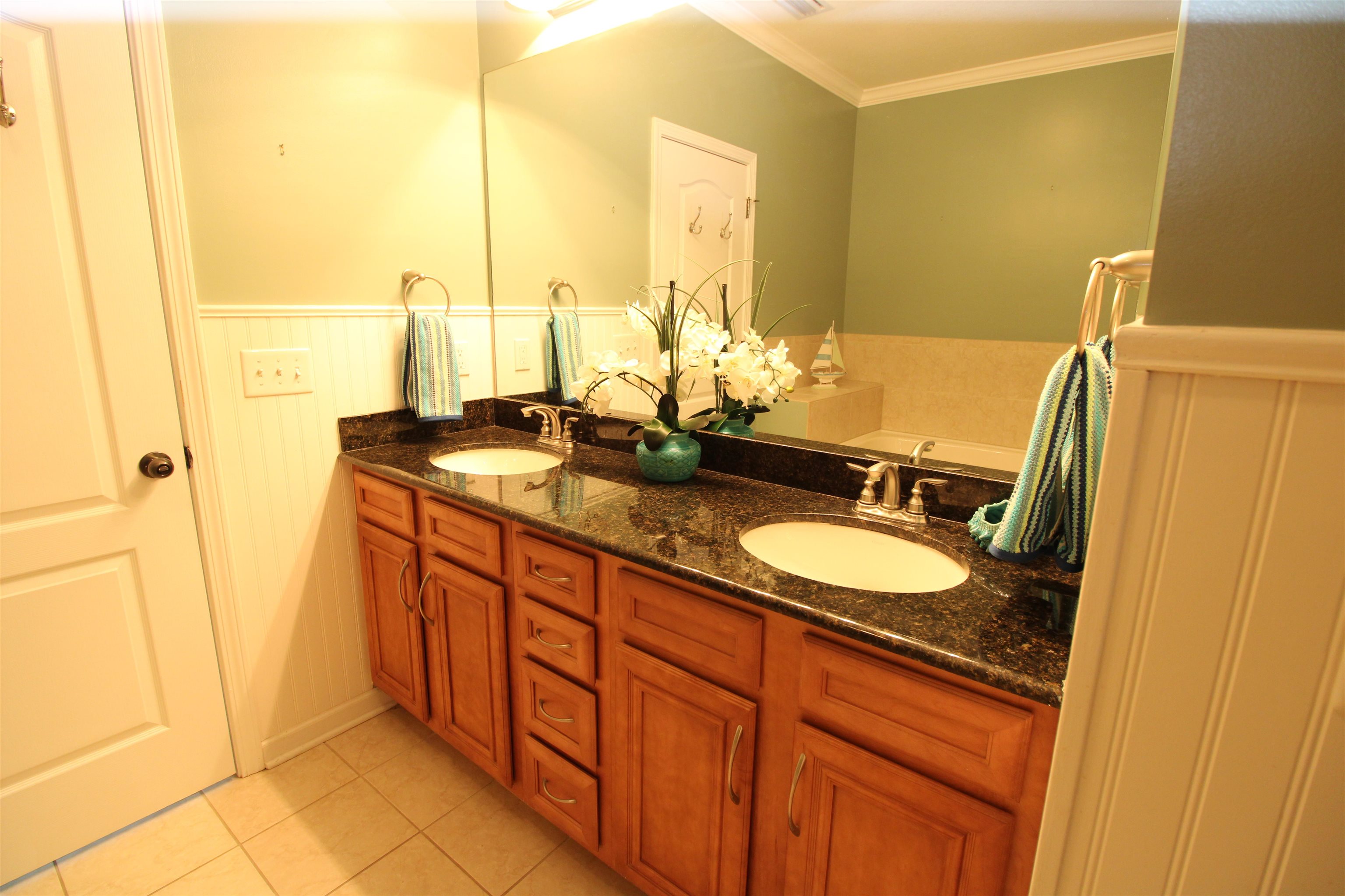 110 Magnolia Crossing Point, Unit 1905 St. Augustine, FL 32086 - Photo 22 of 42 a bathroom with double vanity and a mirror