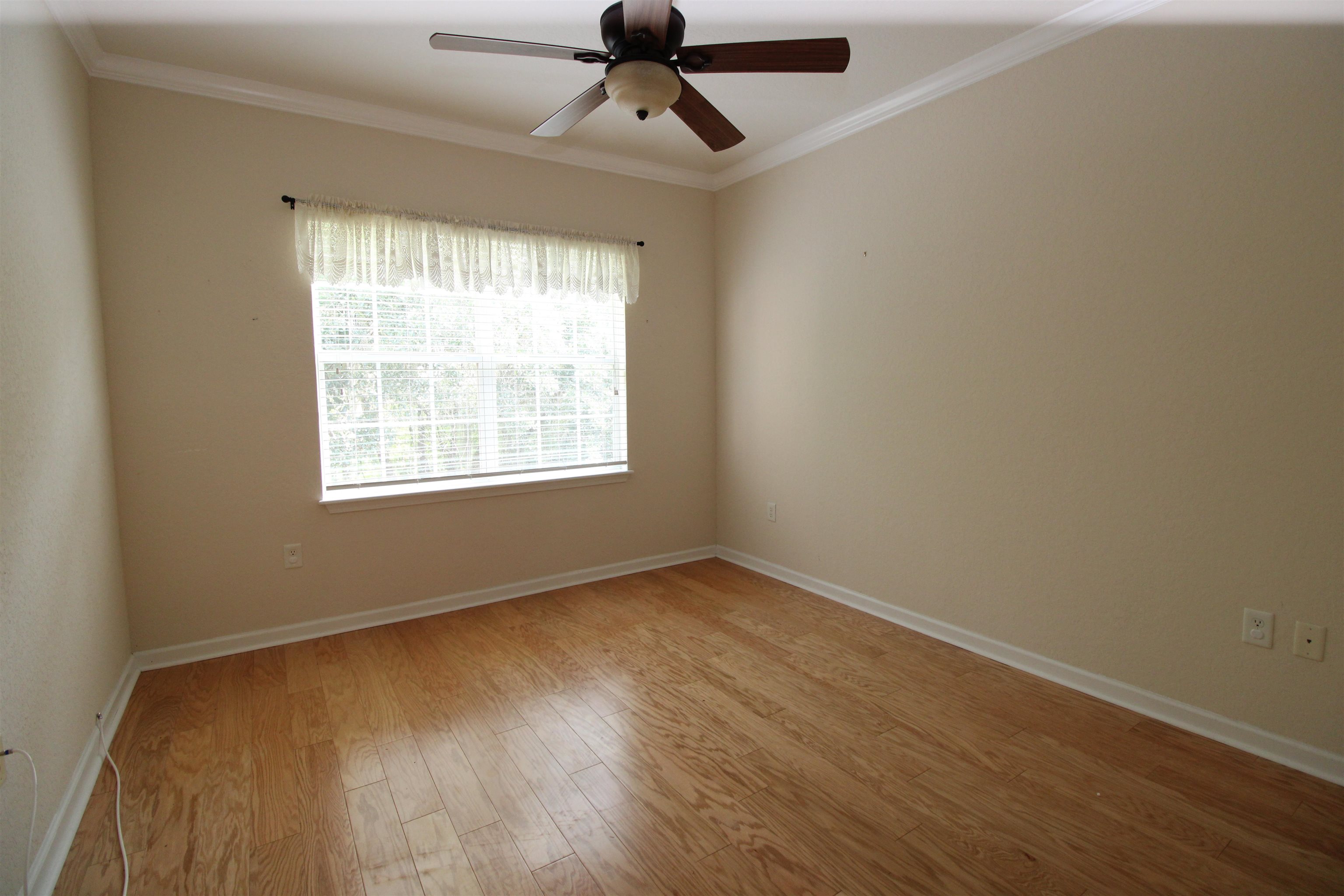 110 Magnolia Crossing Point, Unit 1905 St. Augustine, FL 32086 - Photo 27 of 42 a view of an empty room with wooden floor and a window