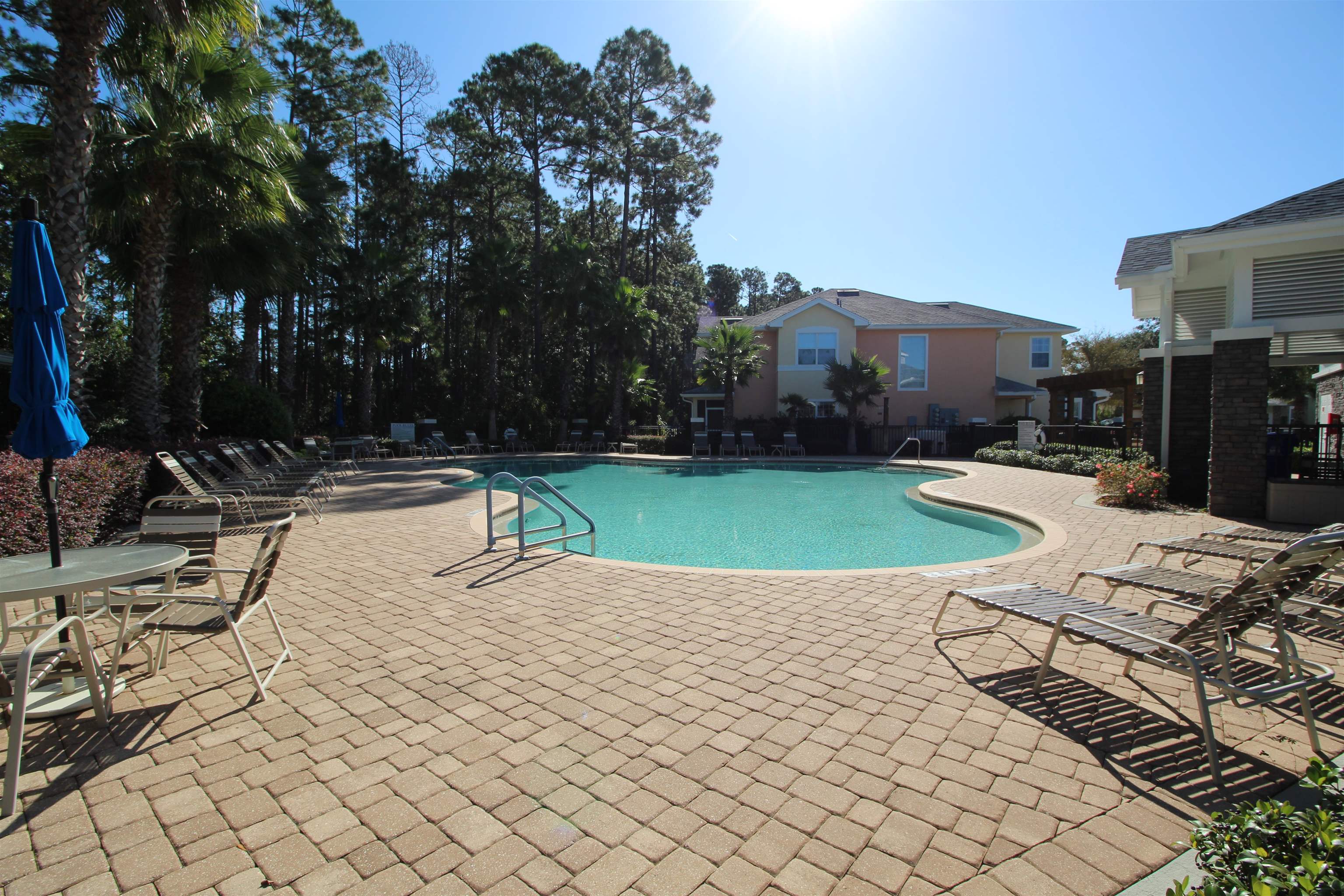110 Magnolia Crossing Point, Unit 1905 St. Augustine, FL 32086 - Photo 40 of 42 a view of a swimming pool with a yard and furniture