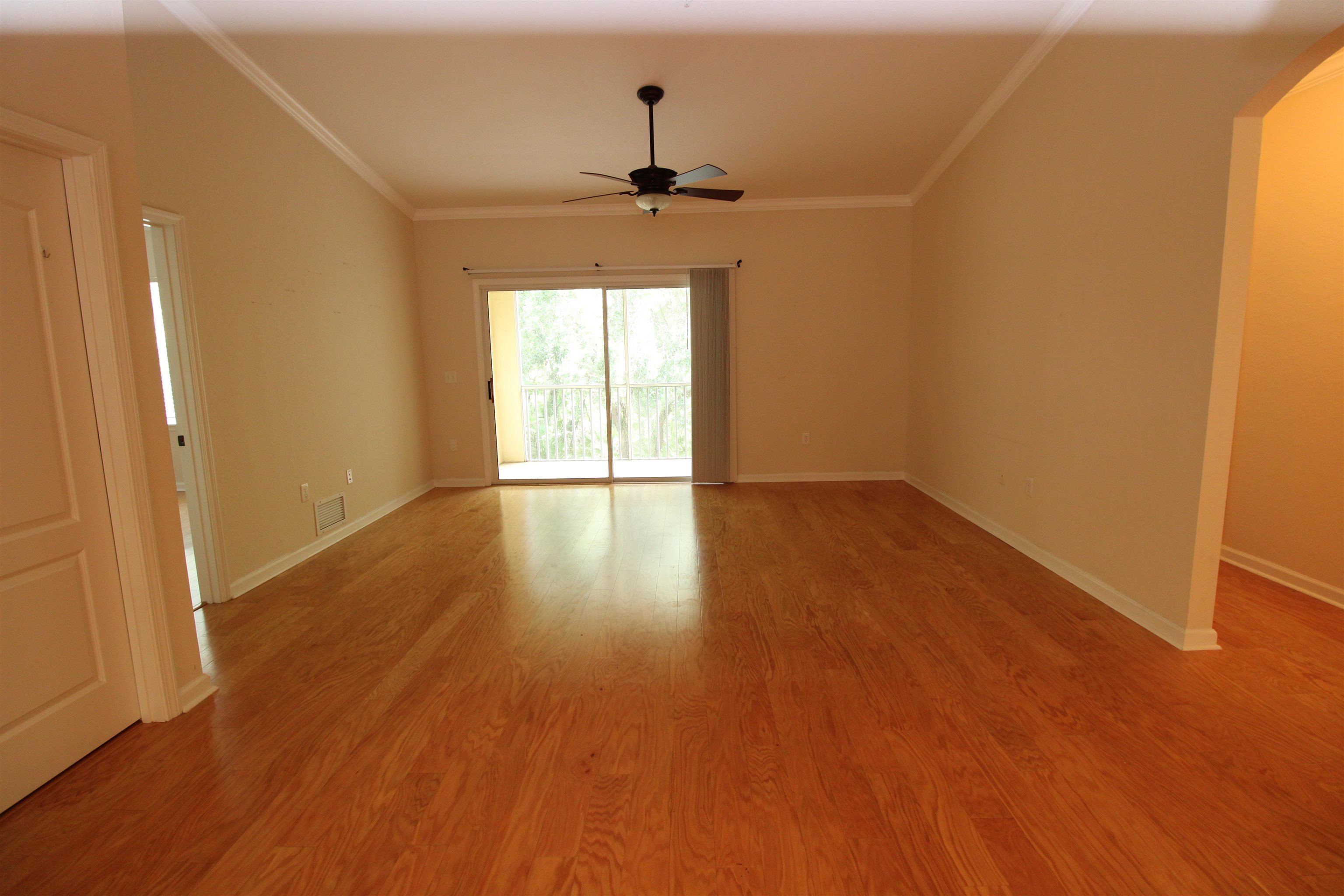 110 Magnolia Crossing Point, Unit 1905 St. Augustine, FL 32086 - Photo 9 of 42 a view of an empty room with wooden floor and a window