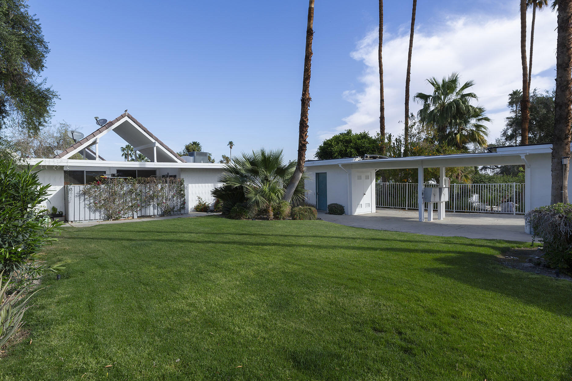 42336 Dunes View Road, Unit 12 Rancho Mirage, CA 92270 - Photo 3 of 29 a front view of a house with garden