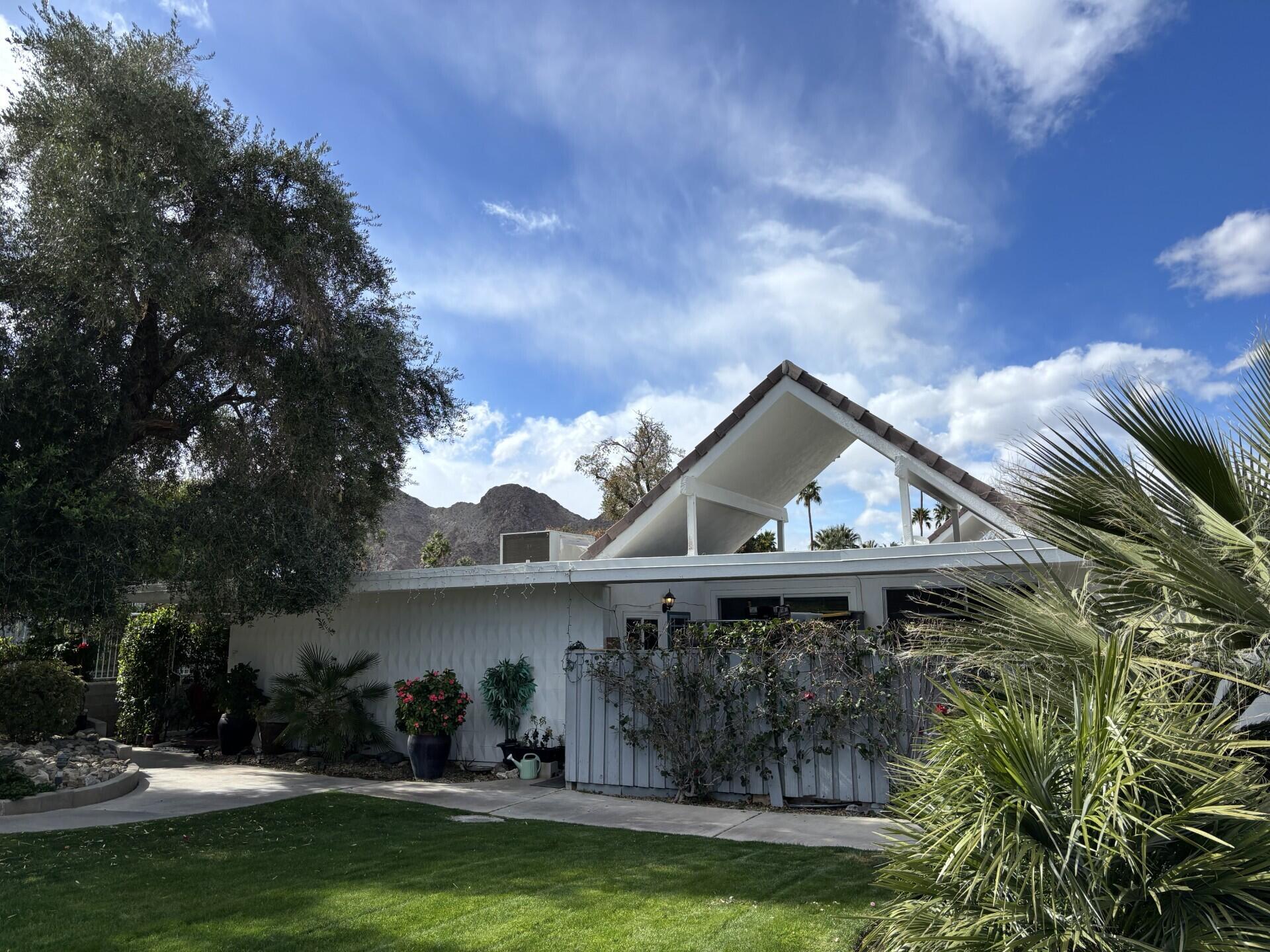 42336 Dunes View Road, Unit 12 Rancho Mirage, CA 92270 - Photo 5 of 29 a view of a house with a yard and a fountain