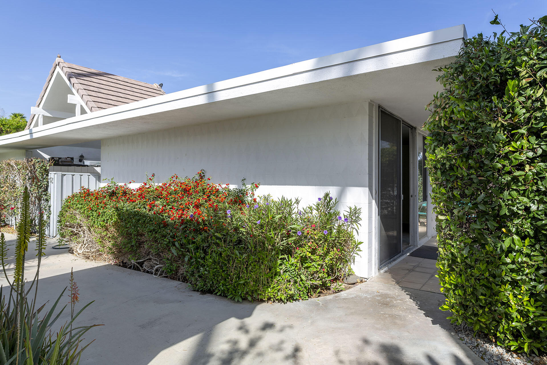 42336 Dunes View Road, Unit 12 Rancho Mirage, CA 92270 - Photo 6 of 29 a front view of a house with garden