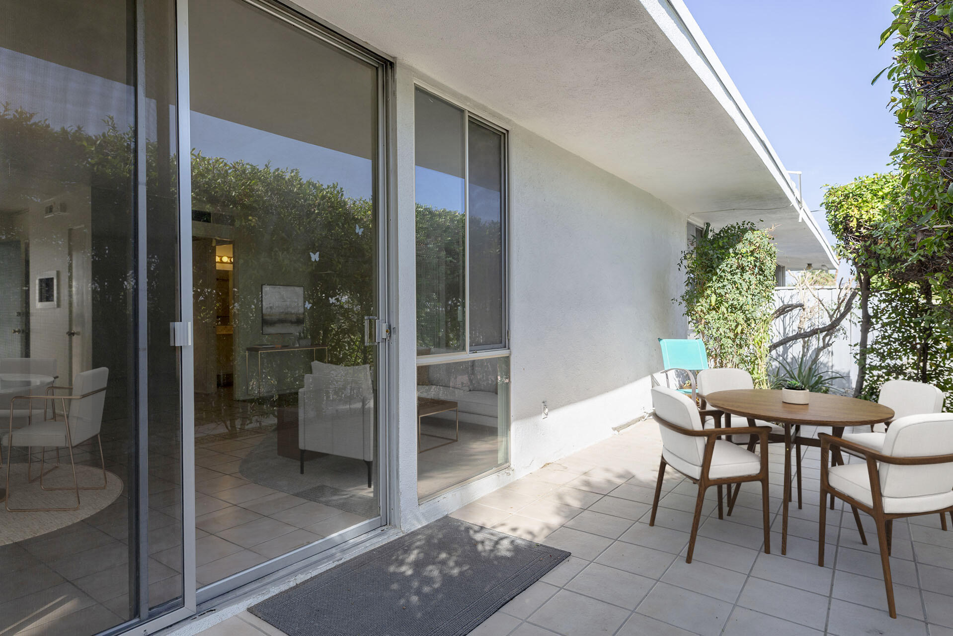 42336 Dunes View Road, Unit 12 Rancho Mirage, CA 92270 - Photo 8 of 29 a patio with yard glass top table and chairs