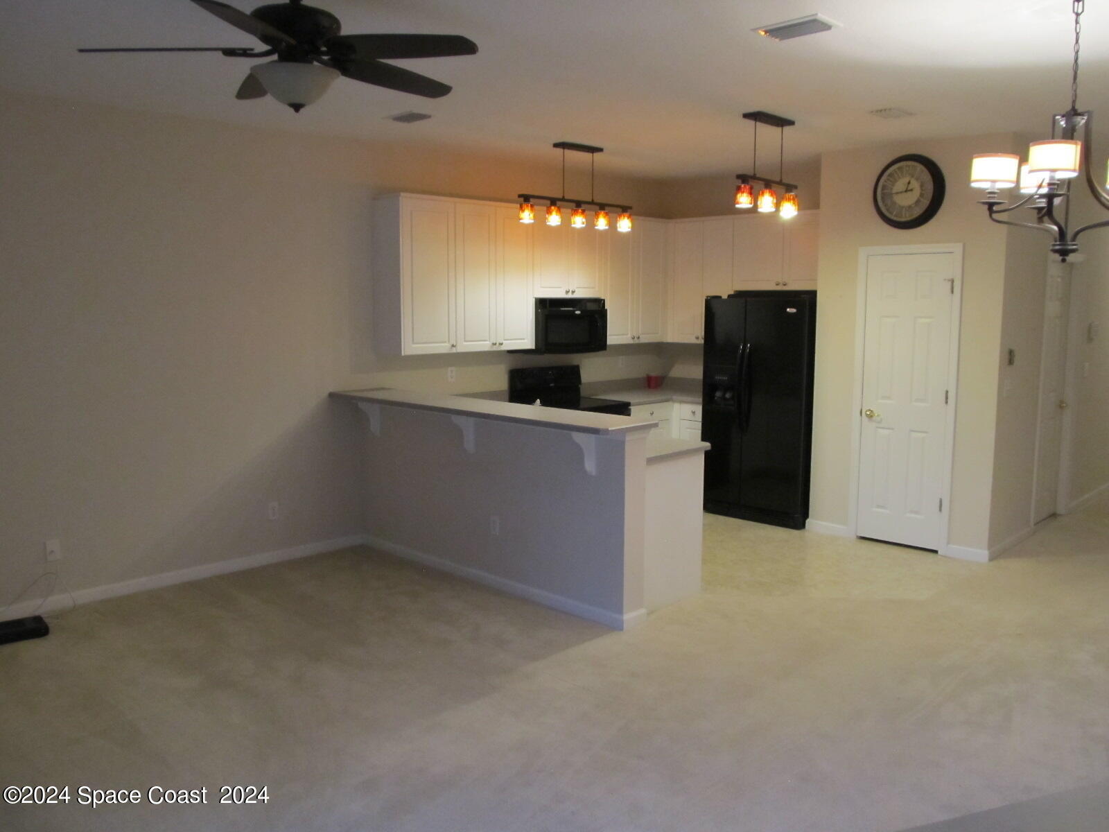 2795 Reston Street, Unit 104 Melbourne, FL 32935 - Photo 9 of 36 a kitchen with a refrigerator and a stove