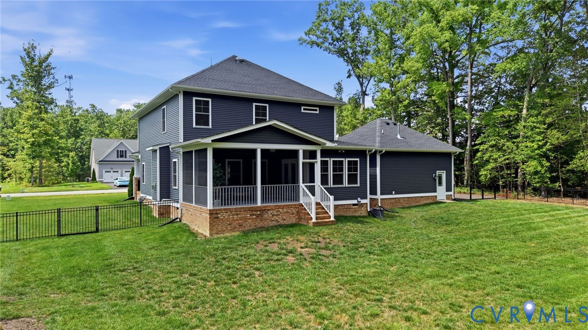 12040 Kenton Ridge Road Ashland, VA 23005 - Photo 44 of 54 Expansive backyard featuring a manicured lawn, scr