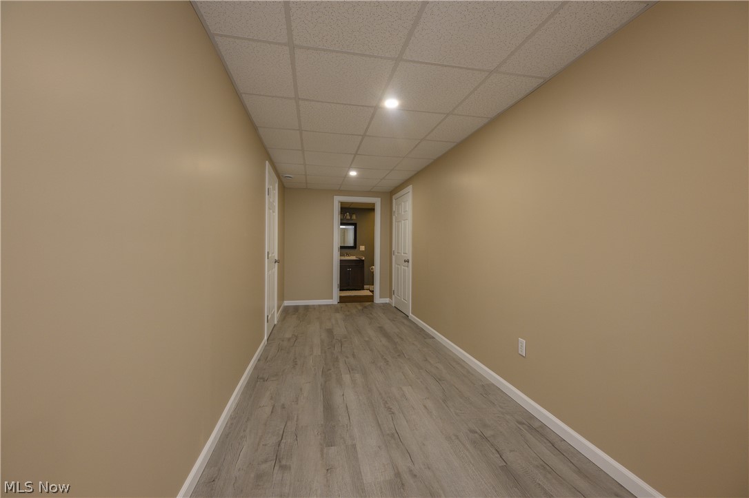 806 Forrest Ridge Drive Dover, OH 44622 - Photo 35 of 36 Hall with a paneled ceiling, recessed lighting, and light wood finished floors