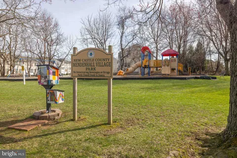 a picture of a bench in front of a wall