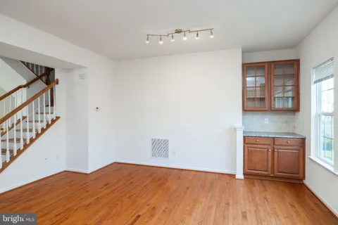 a view of a kitchen with wooden floor and electronic appliances