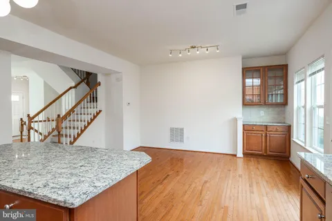 a kitchen with stainless steel appliances granite countertop a sink stove and microwave