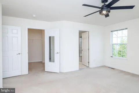 a spacious bathroom with a granite countertop sink a toilet and shower