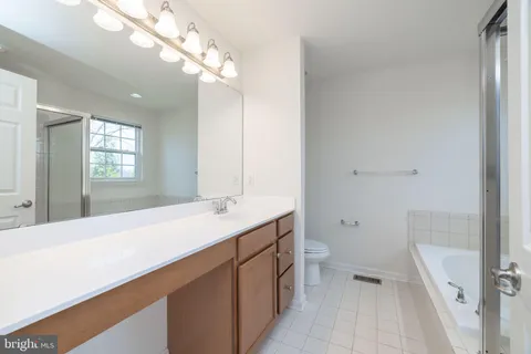 a bathroom with a granite countertop sink a mirror and shower