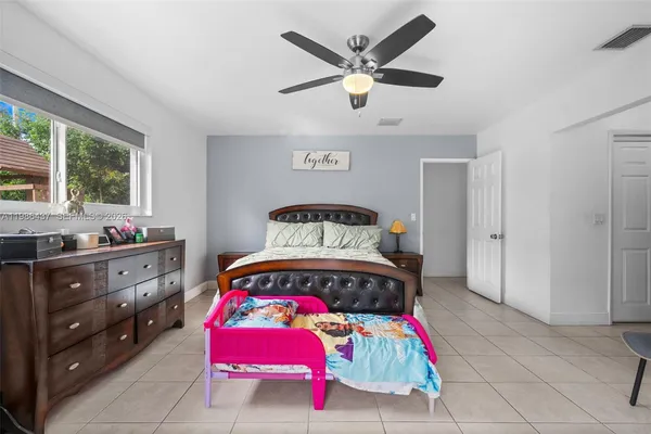 a bedroom with a bed and a dresser