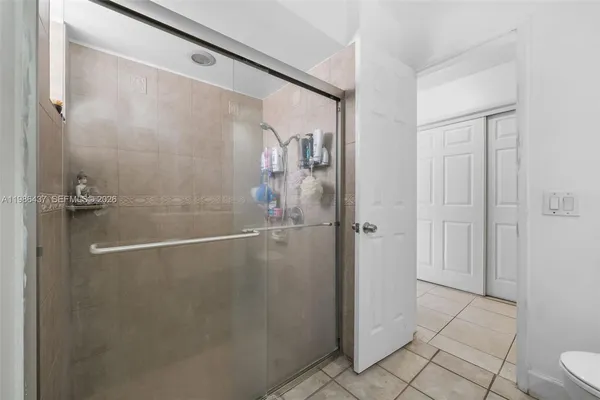a bathroom with a glass shower door