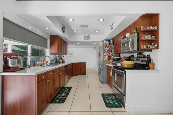 a kitchen with stainless steel appliances granite countertop a sink and cabinets