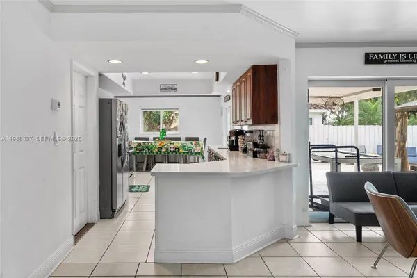 a kitchen with stainless steel appliances granite countertop a refrigerator and a stove top oven