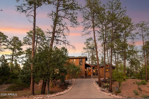 a front view of a house with trees