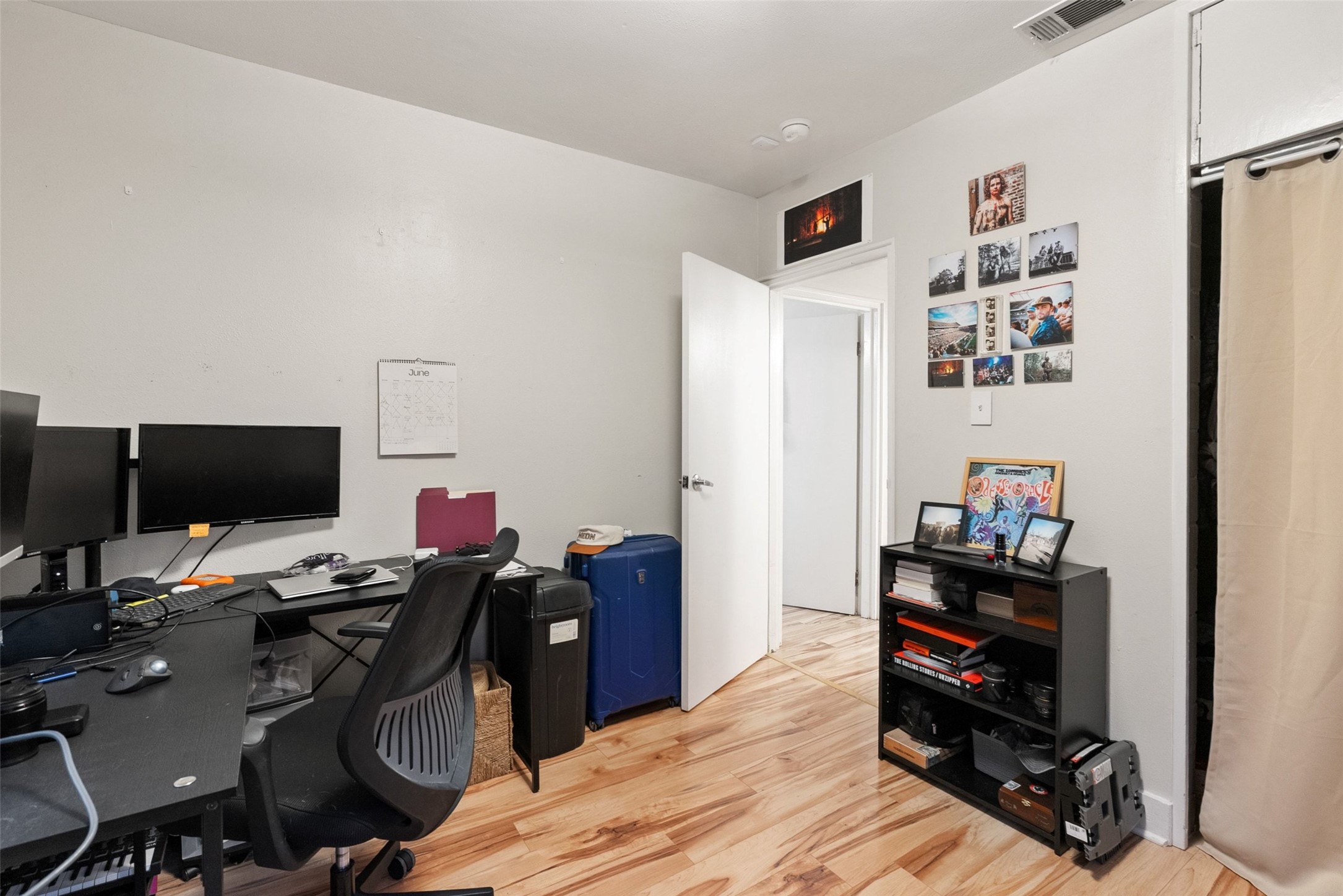 412 West Croslin Street Austin, TX 78752 - Photo 12 of 36 Warm wood-look flooring enhances this versatile room, perfect for a home office.