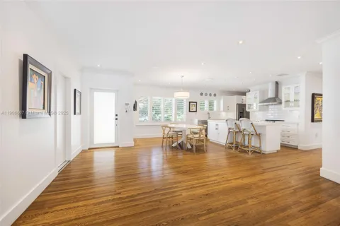 a living room with fireplace and hard wood flooring