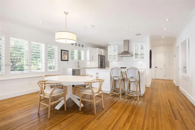 a view of a dining room with furniture window and wooden floor