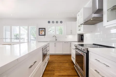 a kitchen with stainless steel appliances granite countertop a stove and a sink