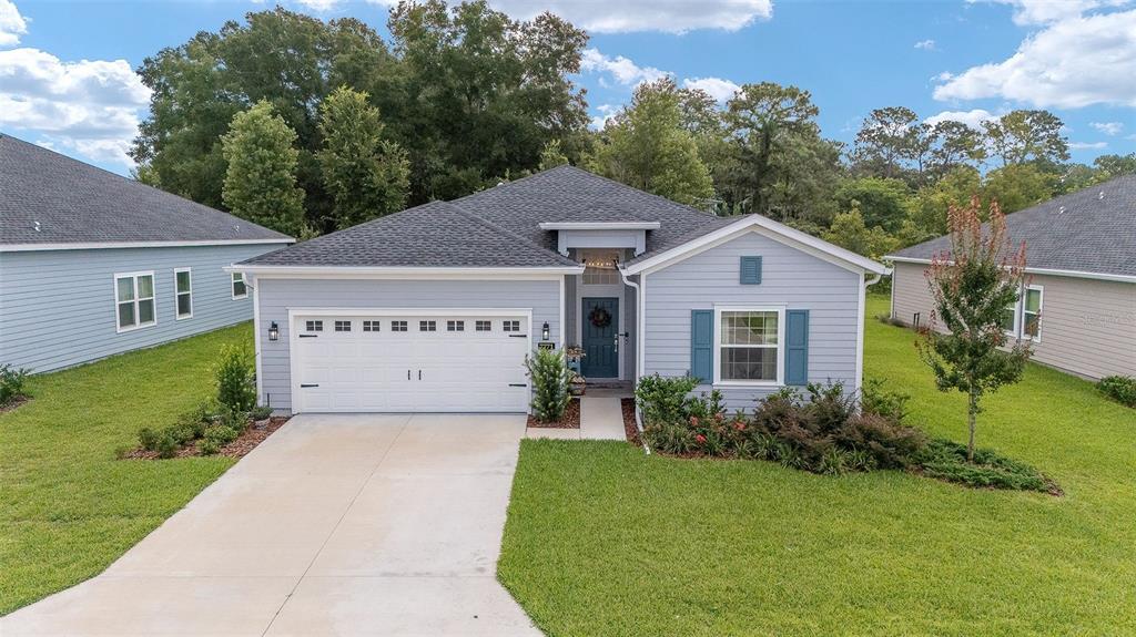7771 Southwest 74th Loop Ocala, FL 34481 - Photo 1 of 1 a view of a house with a small yard and large tree