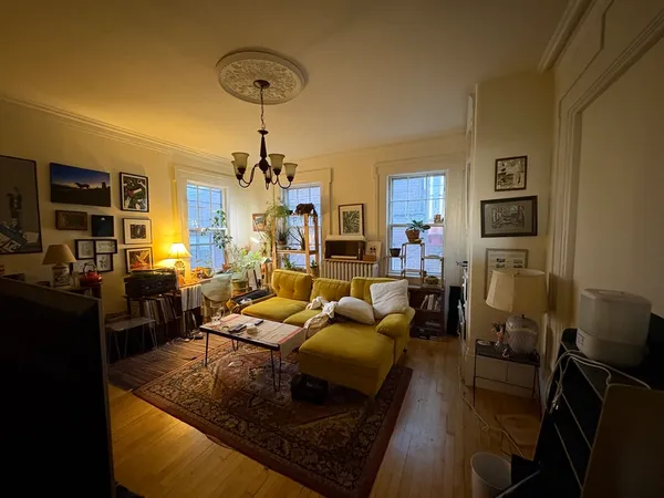 a living room with fireplace furniture and a chandelier