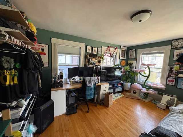 a living room with furniture a window and gym equipment
