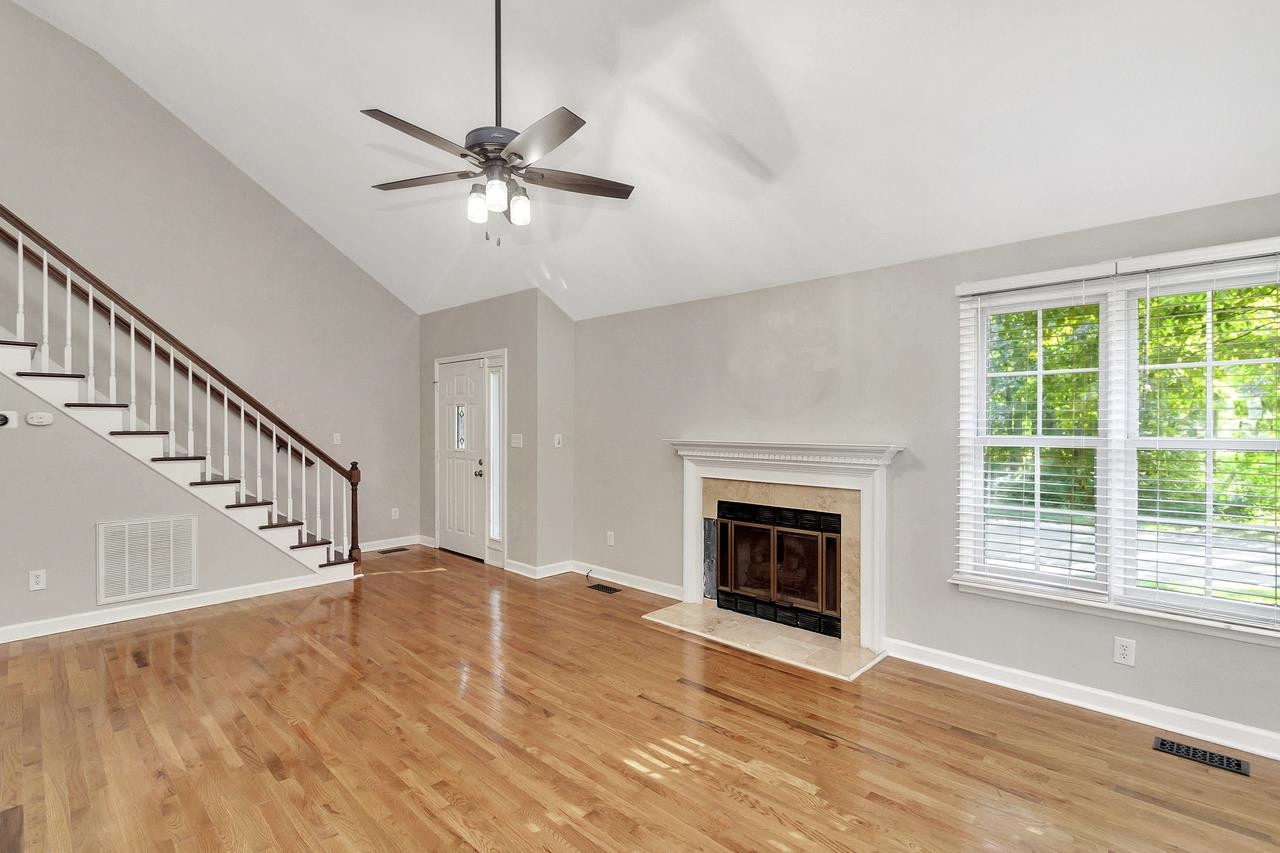 Stairs leading to second floor, fireplace and vaulted ceiling Family Room