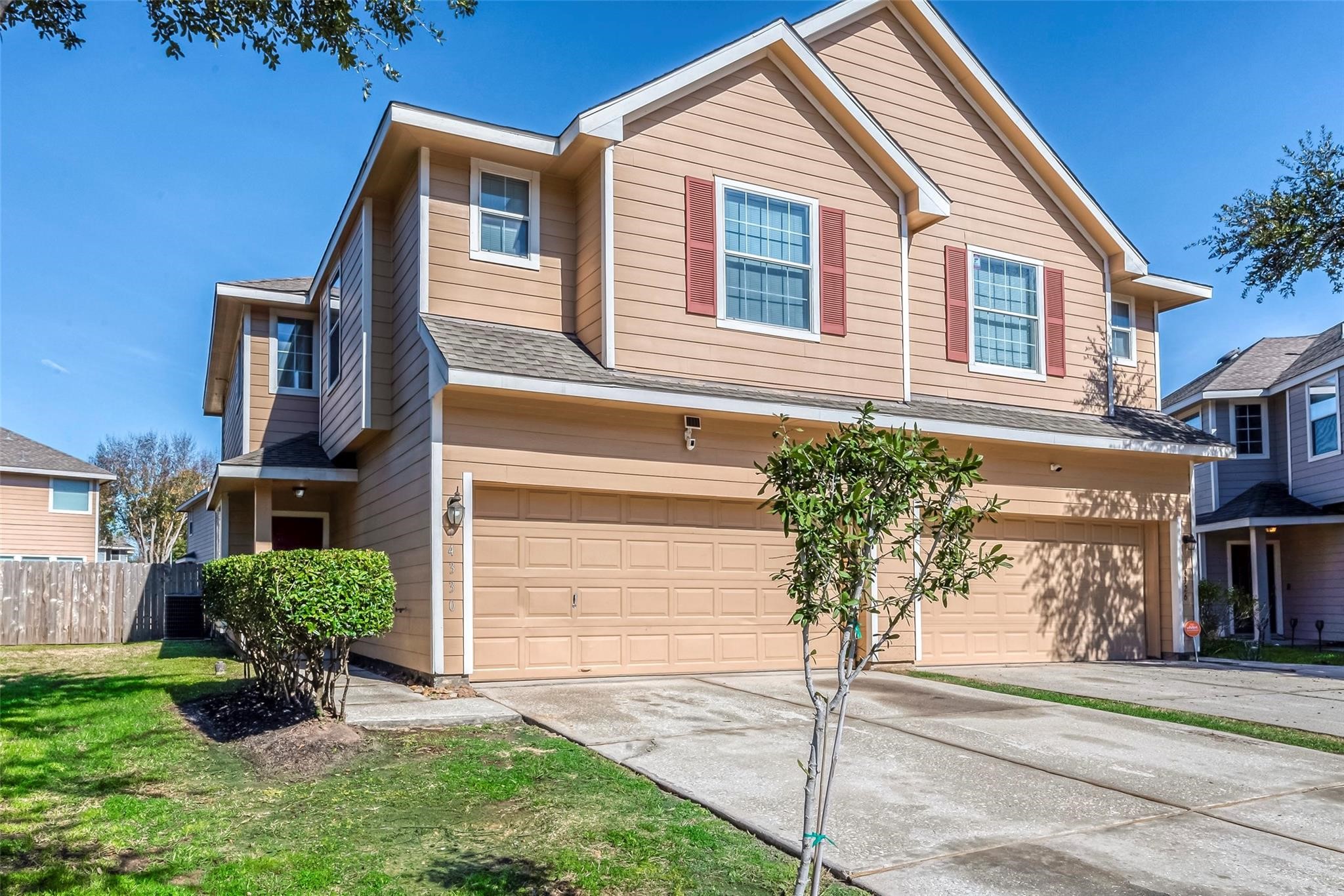 14330 Fairbuff Lane Houston, TX 77014 - Photo 1 of 35 a front view of a house with a yard and garage