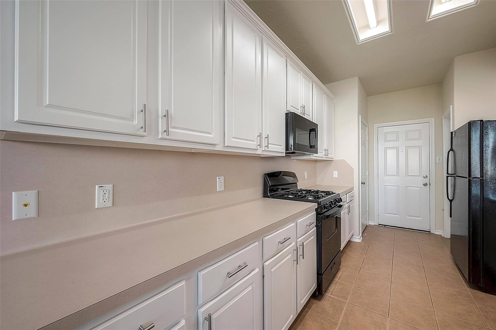 14330 Fairbuff Lane Houston, TX 77014 - Photo 13 of 35 a kitchen with a sink stove and refrigerator